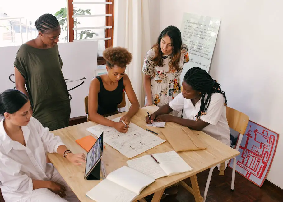 Image description: A diverse group of people working together happily in an office environment.